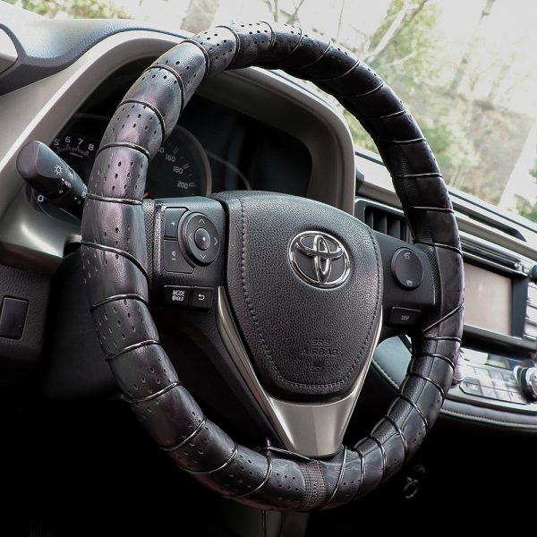 Classic lace on steering wheel cover installed on car interior, showing breathable leather texture and DIY hand-sewn finish.