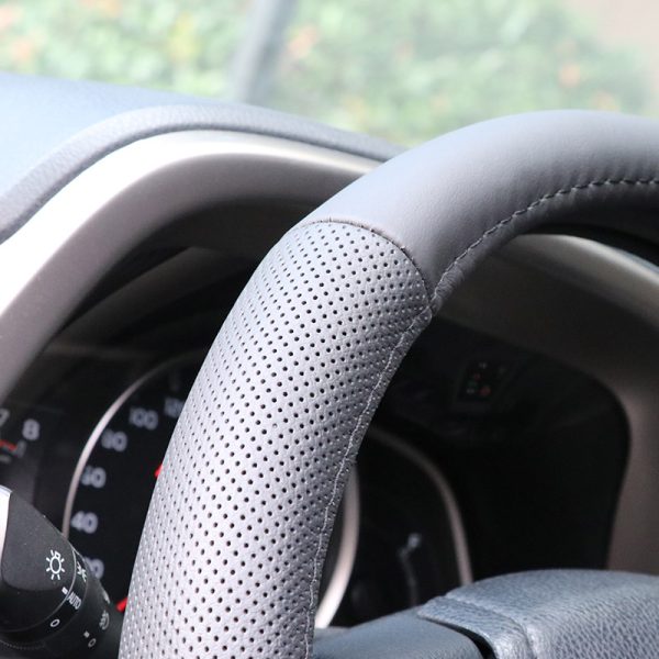 Perforated leather steering wheel cover close-up