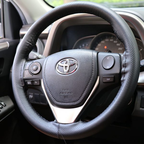 Leather hand stitched steering wheel cover on car interior – front view