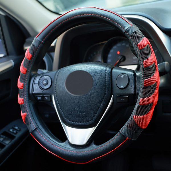 Angled view of red and black 3D honeycomb steering wheel cover with side grip